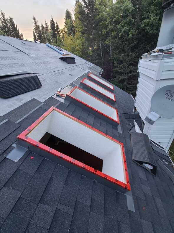 professional skylight installation in progress hoppers shown high pitch roof and 4 skylights