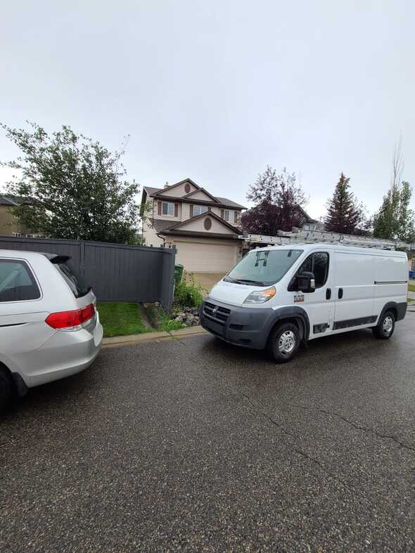 vertex roofing and exteriors van attending an emergency leak in calgary ab