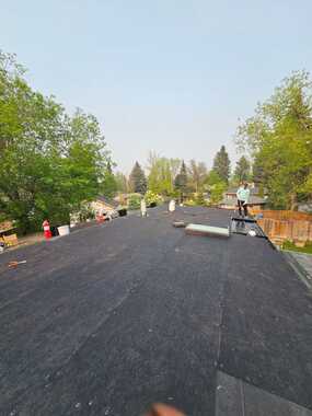 roofer from vertex roofing and exteriors torching down soprema membrane