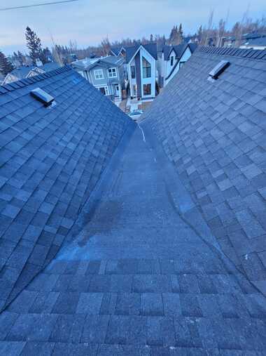 two shingled ridge peaks draining to flat roof base calgary ab