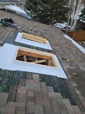 weatherproofing barrier to two skylights shingles removed along skylight perimeter